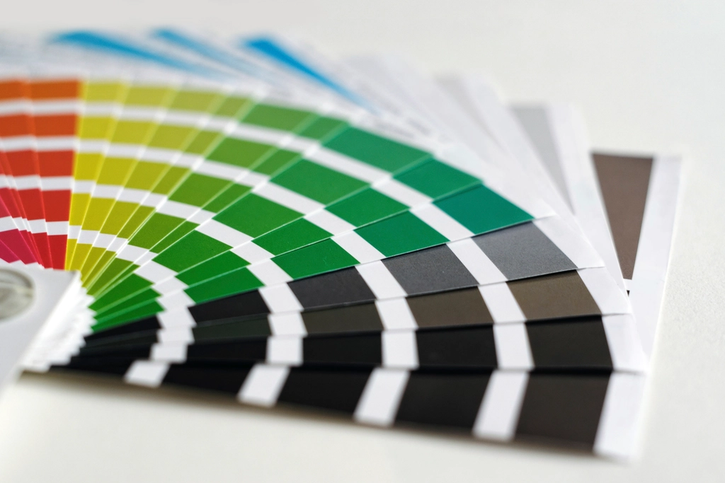A fanned-out set of printed color swatches